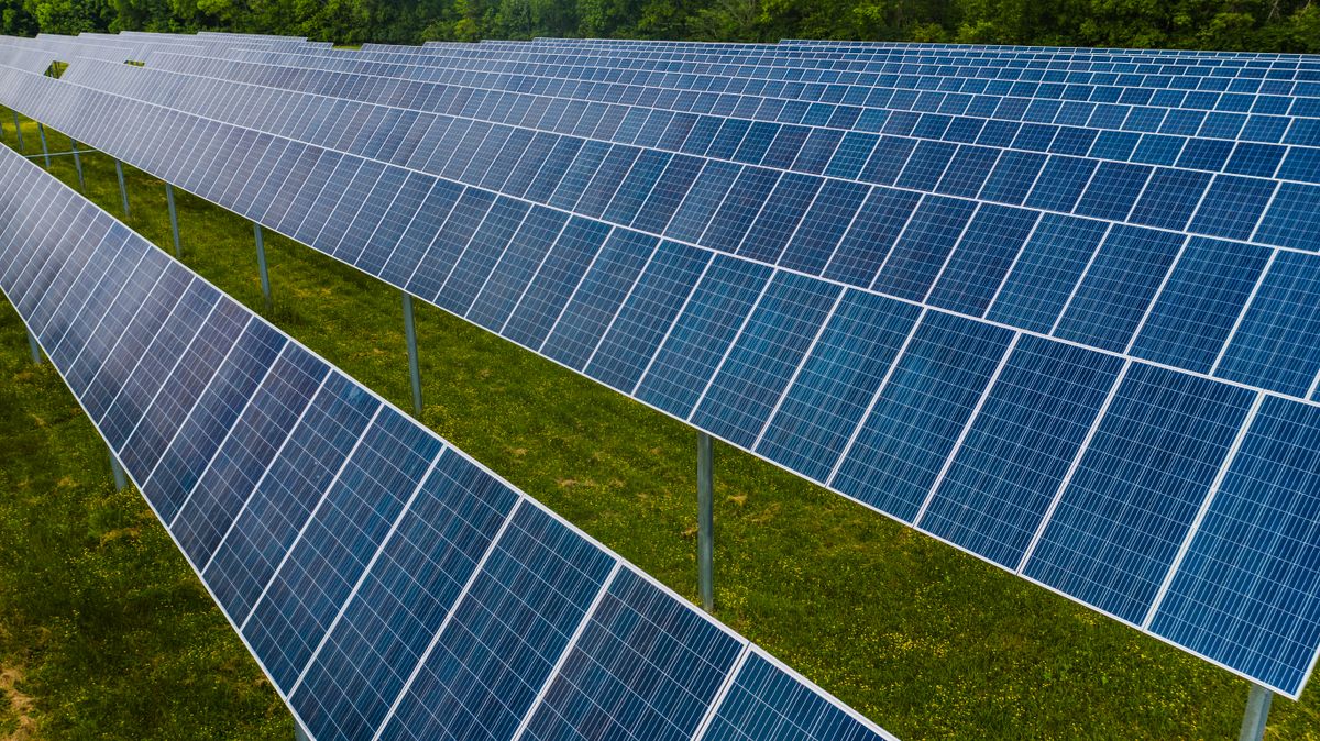 Rows of solar panels on a green field